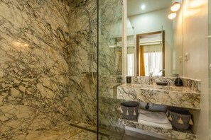 A bathroom with a marble shower and a vanity with a mirror. - Magnificent villa Agathe with heated swimming pool (Marrakech)