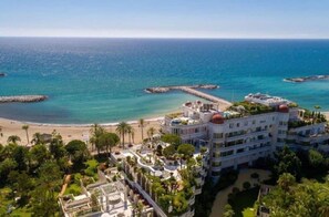 A coastal hotel with multiple buildings, a beach, and a pier. - Charming 1-bedroom Apartment in Marbella, Spain (Marbella)