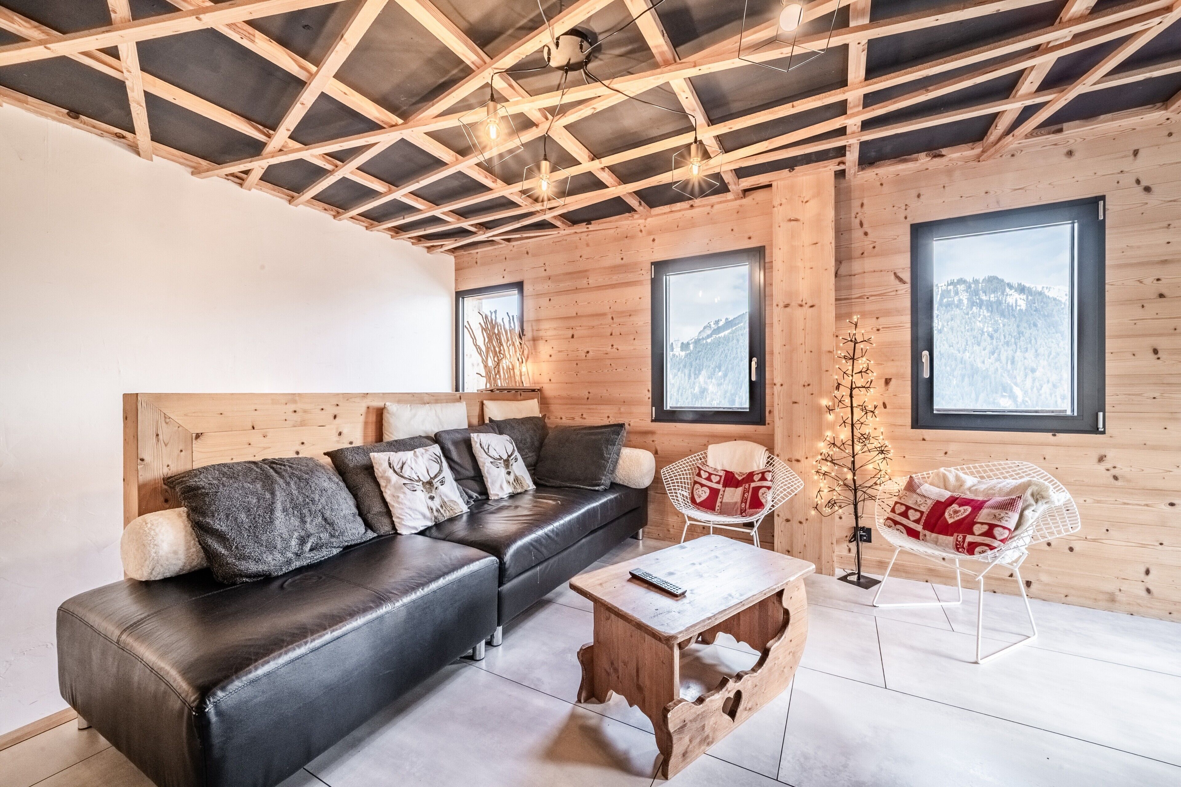 A wooden interior with a sofa, a small table, and a chair.