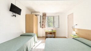 A room with two beds, a desk, a chair, a TV, and a window with curtains. - San Michele - 8 - Bungalow with Sea View Window, Wi-Fi, and Air Conditioning (Mattinata)