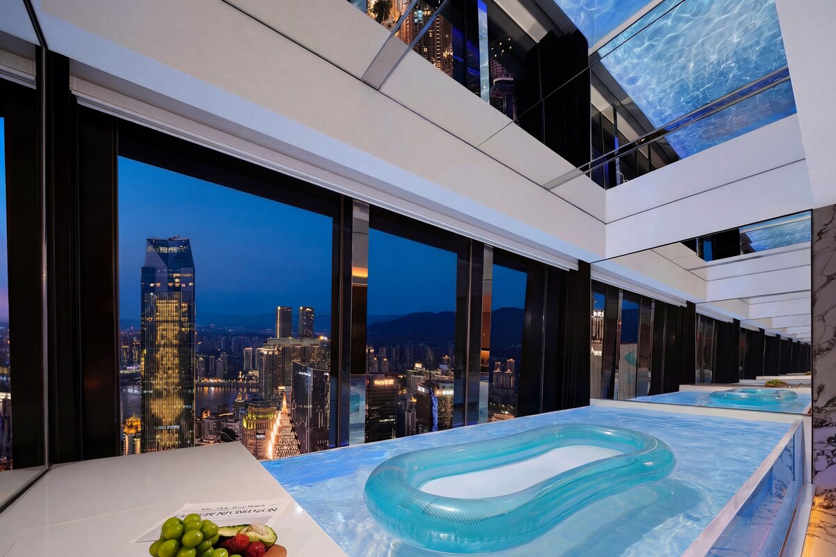 A modern indoor pool with a cityscape view, a wooden board with fruits, and a marble wall.