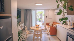 A modern kitchen with a dining area, a refrigerator, and a view to the outside. - Marina Beach Apartments (Alcamo)