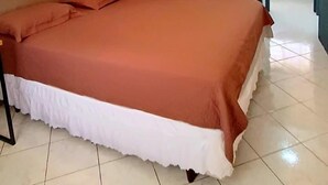 A bedroom with a bed, a dark door, and a view of a balcony. - 2 bed apart in Asa Sul • Premium Location • Next Esplanada, Lake, Parks, Airport (Brasília)