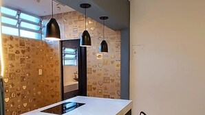 A modern kitchen with a long island, pendant lights, and a patterned backsplash. - 2 bed apart in Asa Sul • Premium Location • Next Esplanada, Lake, Parks, Airport (Brasília)