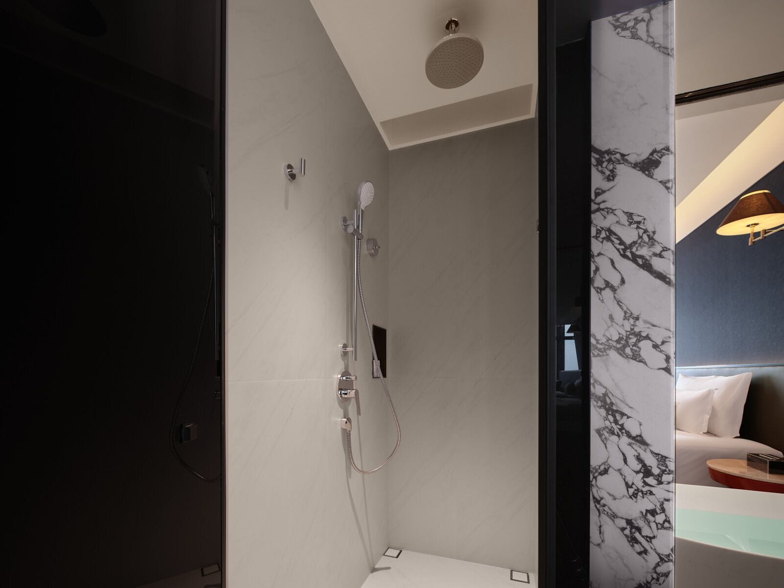 A modern bathroom with a shower, a toilet, and a sink.