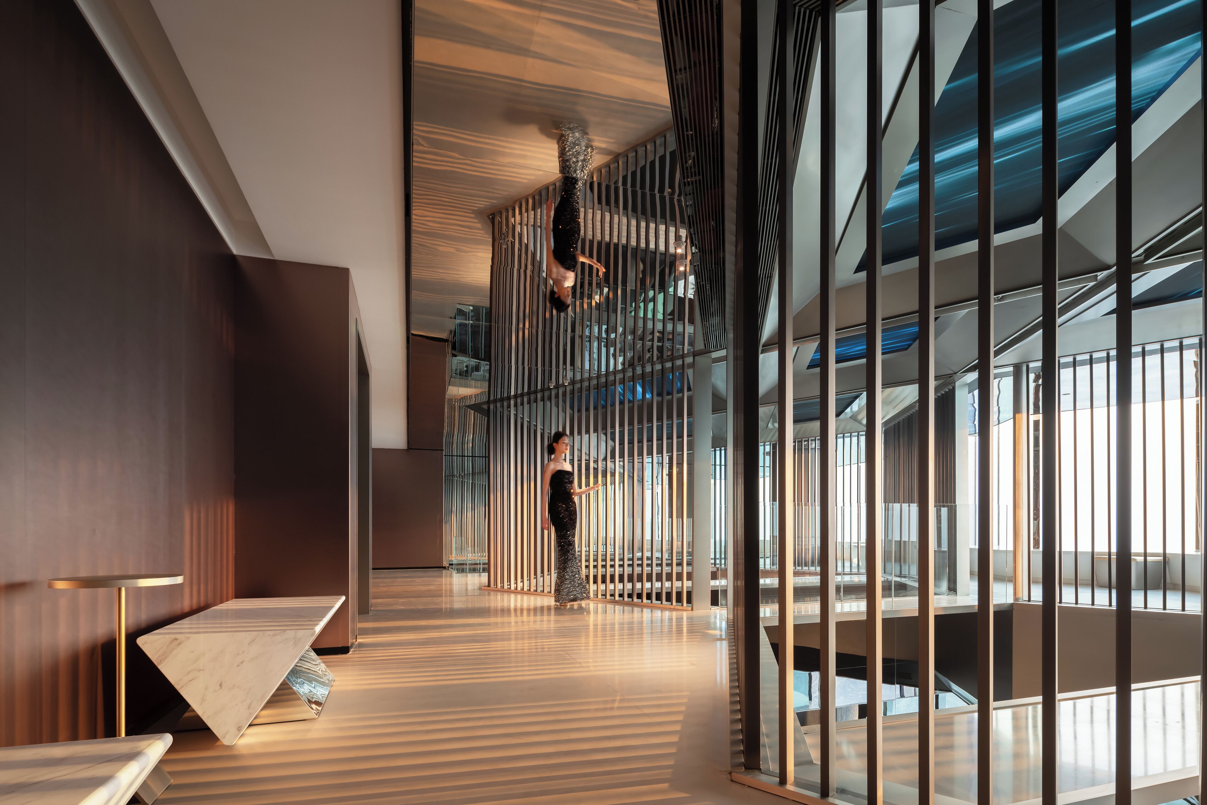 A modern interior with a high ceiling, a staircase, and a railing.
