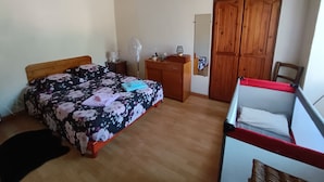 A bedroom with a wooden bed, a bedside table with a lamp, a dresser, a mirror, and a wardrobe. - 🌿Village house full of charm🌿 Haven of peace 5 minutes from a river 🌿 (Manso)
