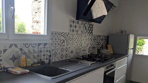 A modern kitchen with a built-in dishwasher, a stove, and a refrigerator.