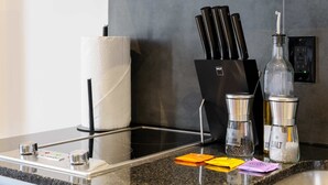 A kitchen counter with a paper towel holder, a knife block, salt and pepper shakers, and a digital scale. - w Appealing Loft in the Heart of Interlomas (Huixquilucan)