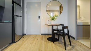 A modern kitchen with a built-in refrigerator, a dining area with a round table and chairs, and a large mirror on the wall. - w Appealing Loft in the Heart of Interlomas (Huixquilucan)