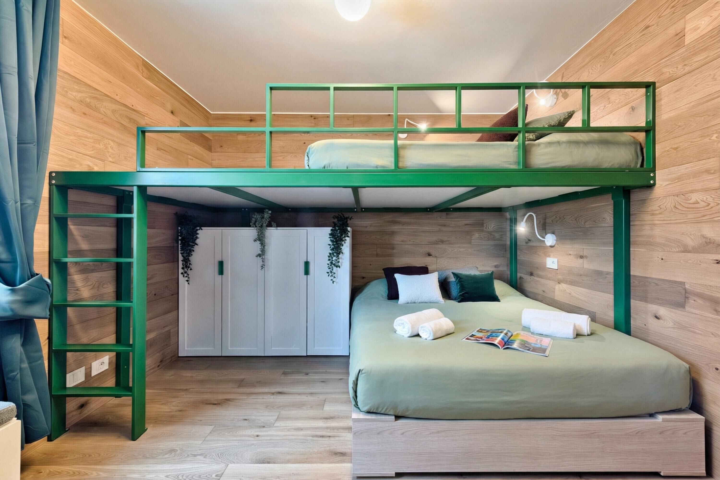 A bunk bed with a ladder, a bedside table, a magazine, and a towel on the lower bunk.