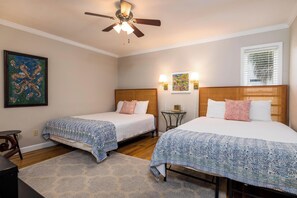 A hotel room with two beds, a ceiling fan, wall-mounted lamps, a painting, and a window with blinds. - 360 Wahoo Drive (Fripp Island)