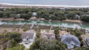 An aerial view of a coastal residential area with houses, a marina, and a beach. - 360 Wahoo Drive (Fripp Island)
