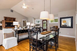 A spacious living area with a dining table, chairs, and a ceiling fan. - 360 Wahoo Drive (Fripp Island)