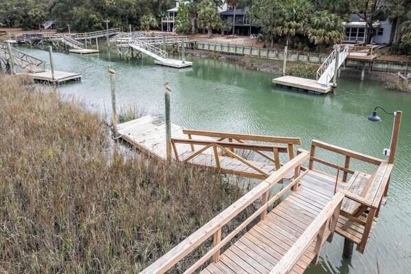 A wooden dock extending into a calm body of water with a bridge connecting to another dock. - 360 Wahoo Drive (Fripp Island)