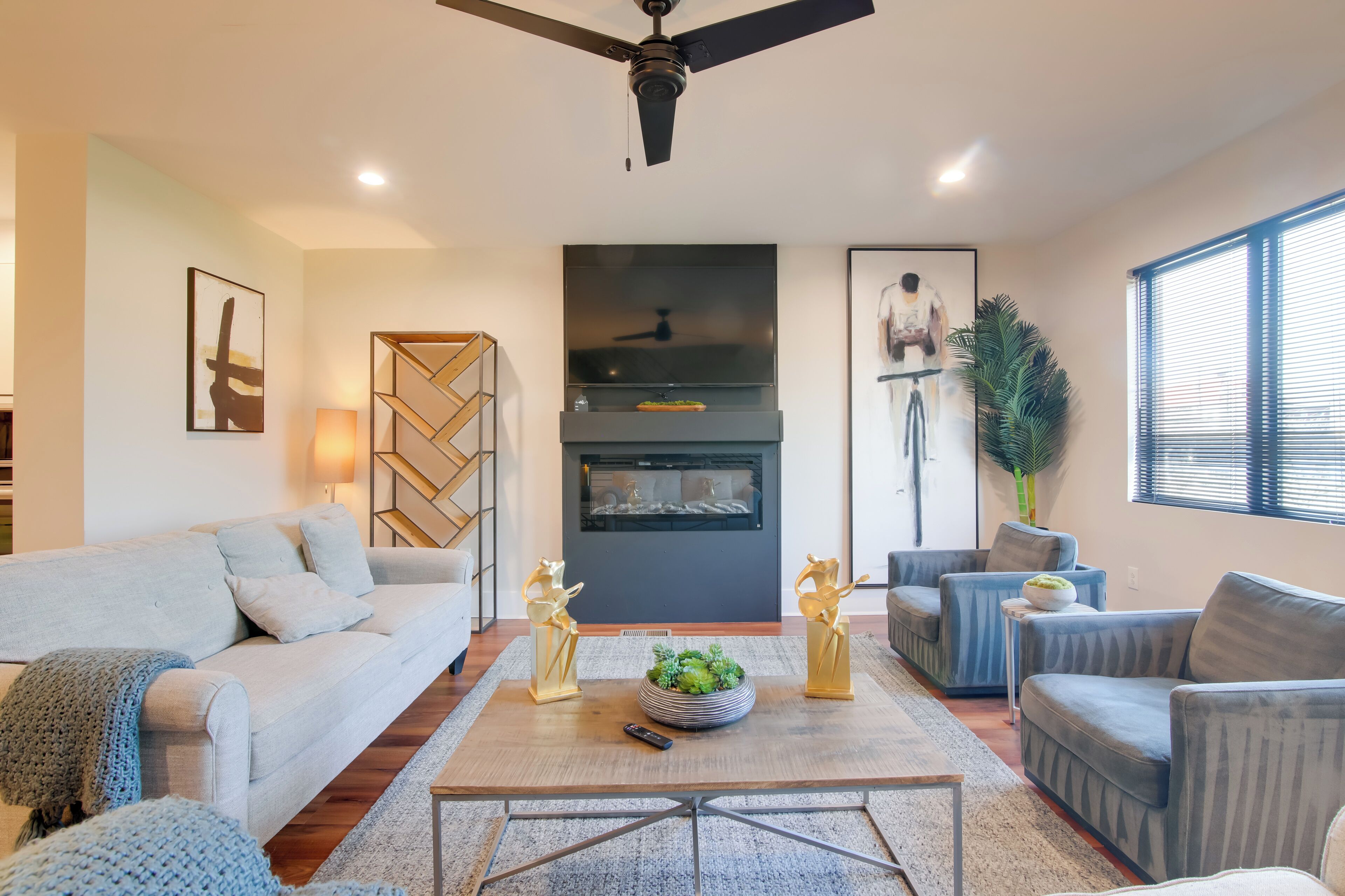 A modern living room with a sofa, armchairs, a coffee table, and decorative items.