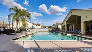 A swimming pool with lounge chairs and palm trees. - 5 Mi to Wdw! Spacious Resort Escape w/ Pool Access (Kissimmee)