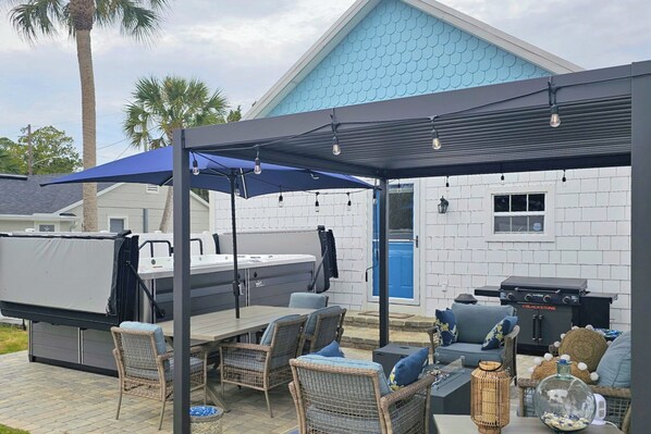 An outdoor patio area with a covered seating area, a grill, and a pool. - < 1 Mi to Ramp! Boater's Retreat in Edgewater (Edgewater)