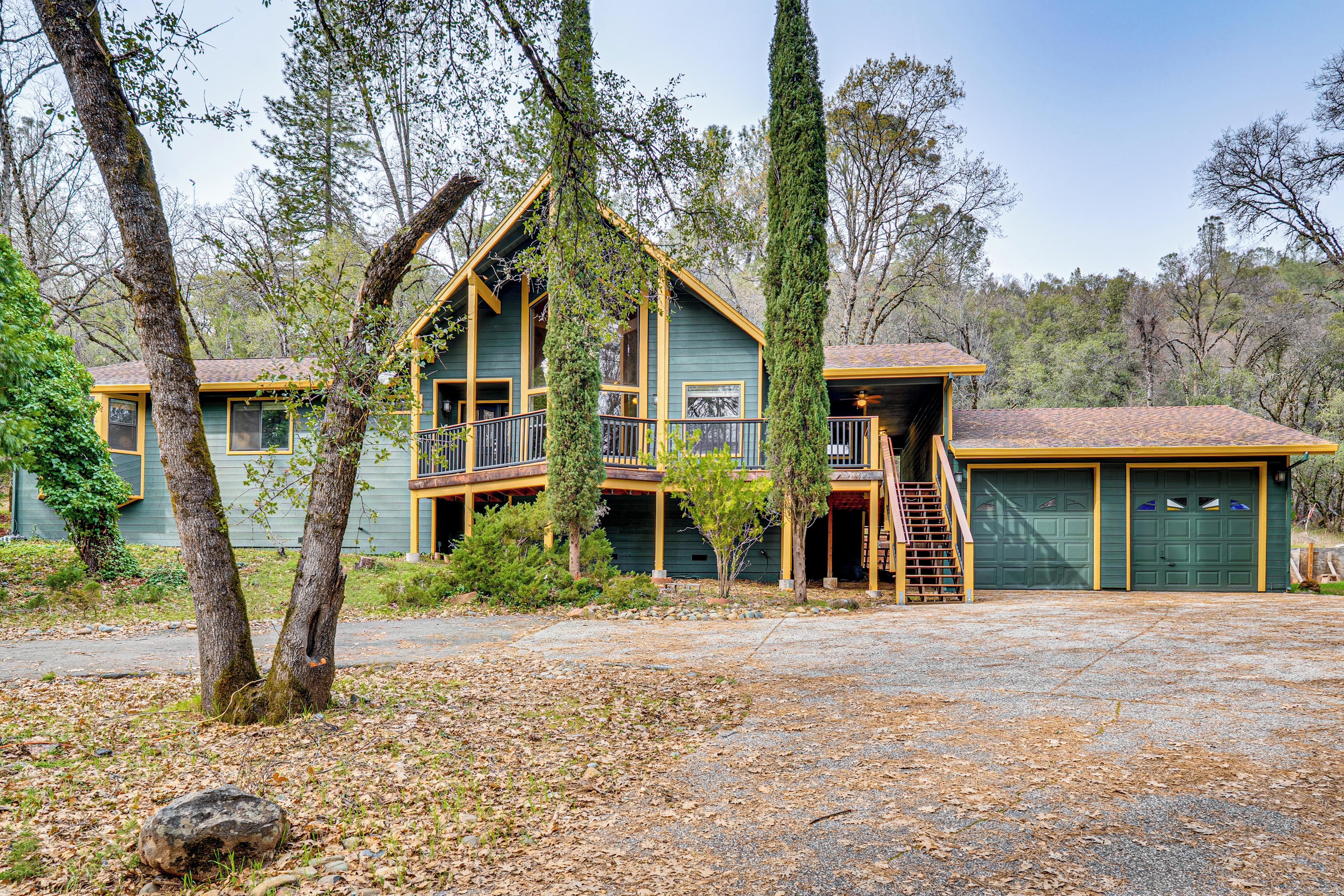 A two-story house with a balcony, a garage, and a covered porch area.