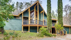 A two-story house with a balcony, a garage, and a driveway. - Arts, History & Adventure! Gold Country Getaway (Grass Valley)