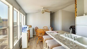A compact kitchen with a dining area, a water dispenser, and a ceiling fan. - Hualapai Mountain Views & Deck! Yucca Getaway (Yucca)