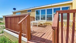 A wooden deck with a table and chairs, a satellite dish, and a windowed building. - Hualapai Mountain Views & Deck! Yucca Getaway (Yucca)