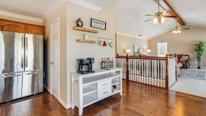 A kitchen with a stainless steel refrigerator, a white console table with drawers, a coffee station, and a wooden ceiling fan. - 'texoma Shores Hideaway' Family Home w/ Water View (Pottsboro)