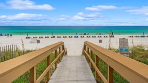 A wooden boardwalk leading to a beach with clear turquoise water and a sandy shore. - Sterling Beach 1202 Luxury Beachfront, Heated Pool, Walk in Shower, FREE Golf (Panama City Beach)