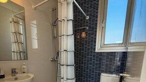 A bathroom with a shower, toilet, sink, and a window. - Amáni Seaview 3 Bedrooms Luxury Villa (Pegeia)