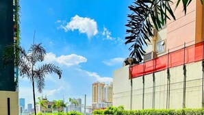 A swimming pool with lounge chairs and potted plants. - MJM Cityscape At Red Residences Makati (Makati)
