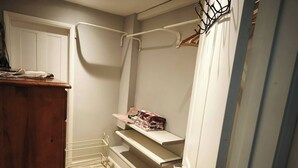 A small, narrow room with a wooden dresser, a metal drying rack, and a shelf with folded clothes. - Groombridge 1 Bed Self Catered Flat, can Sleep 4 (Royal Tunbridge Wells)