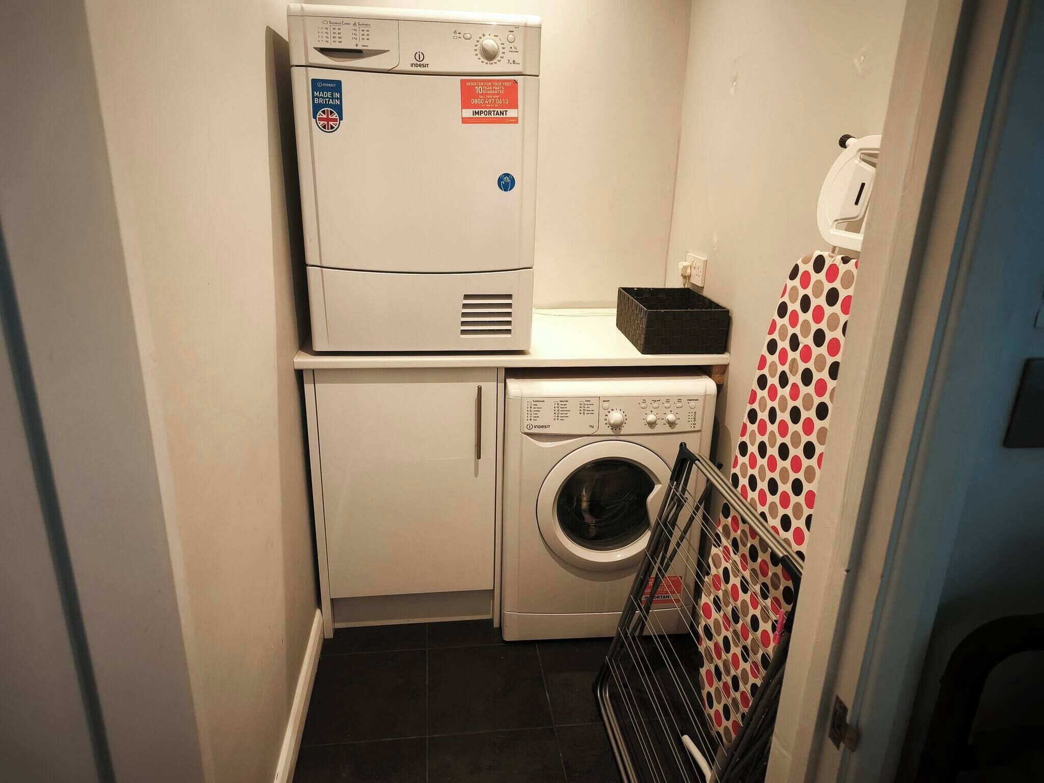 A compact laundry room with a washing machine, a dryer, and a stacked washer-dryer unit.