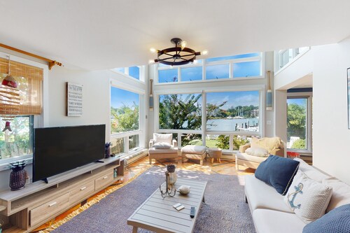 Dog-friendly riverfront home with dock, 2 balconies, waterside patio, & grill