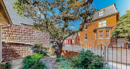 Historic downtown townhome with brick courtyard, sunroom & parking