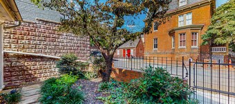 Historic downtown townhome with brick courtyard, sunroom & parking