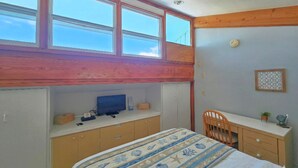 A bedroom with a bunk bed, a desk, and a chair. - Park Place -Parkside Dream -Downtown w/ Gulf View! (Cedar Key)