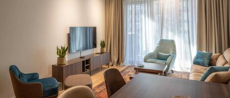Luxury Apartment, City View | Living area | 50-inch flat-screen TV with cable channels