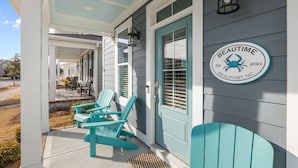 A porch with turquoise Adirondack chairs, a teal door, and a sign that reads "BEAUTIME Beaufort, NC." - Beautime-Pet Friendly Home in Downtown Beaufort, NC (Beaufort)