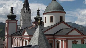 A church with a prominent spire and multiple domes, set against a mountainous backdrop. - Hotel zum Kirchenwirt Mariazell (Mariazell)