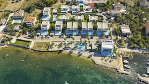 An aerial view of a coastal resort with multiple villas, a swimming pool, and a marina. - The Palms Resort 2BR Villa Dream Four with Pool (Tkon)