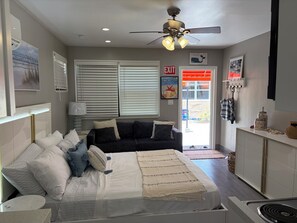 A bedroom with a bed, a bedside table, a dresser, a ceiling fan, and a window with blinds. -  Hollywood  Beach ,perfect for your next getaway ,close to Miami events (Hollywood)