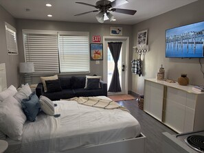 A hotel room with a bed, a sofa, a TV, and a desk. -  Hollywood  Beach ,perfect for your next getaway ,close to Miami events (Hollywood)