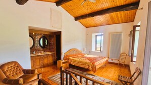 A cozy room with a wooden ceiling, a bed with a striped blanket, a wooden chair, and a small table. - Authentic Tuscany Stay with Epic Views & Space for All (Cardoso)