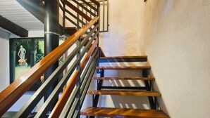 A wooden staircase with a metal railing, leading to an upper floor. - Authentic Tuscany Stay with Epic Views & Space for All (Cardoso)