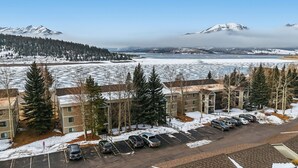 A multi-story parking garage with several cars parked, surrounded by snow-covered ground and trees. - Buffalo Mtn Views - Spacious Dillon Retreat (Dillon)