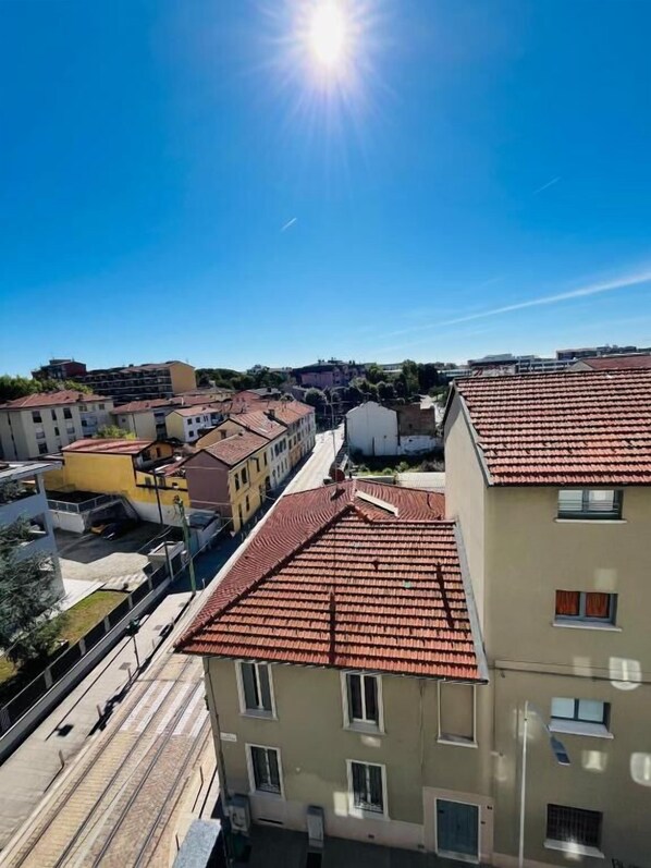 A residential area with buildings featuring red-tiled roofs and a clear blue sky. - Milano Bicocca Apartment & Rooms (Cinisello Balsamo)