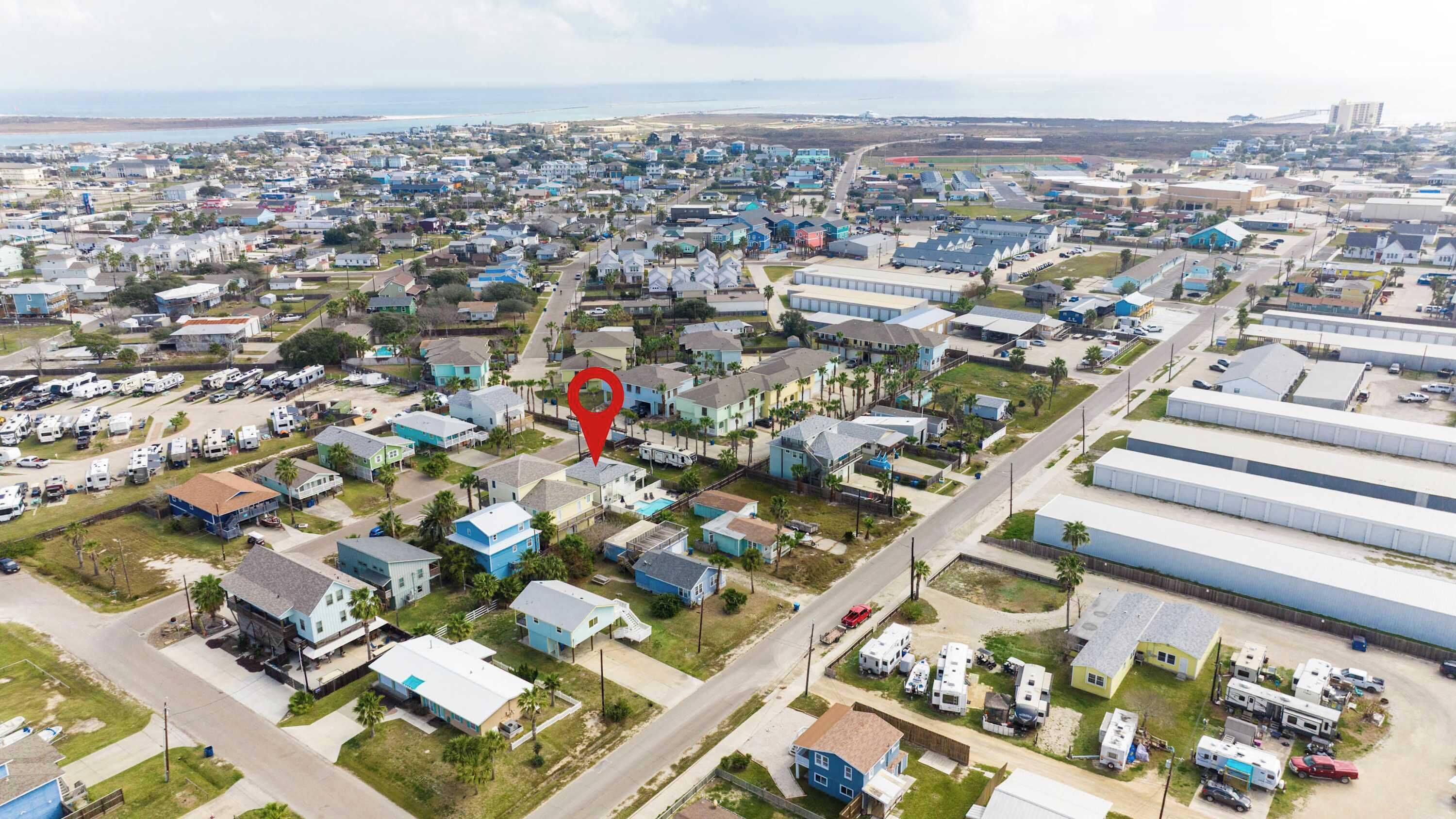An aerial view of a residential area with houses, RVs, and industrial buildings.