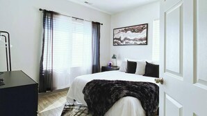 A bedroom with a bed, a desk, a lamp, and a painting on the wall. - 🔥 Ring of Fire Retreat — Johnny Cash Hideaway Walkable East Nashville 🖤🎸 (Nashville)