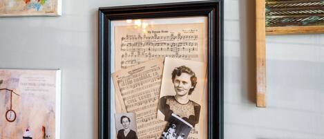 A framed photograph with musical notes and a vintage photograph.