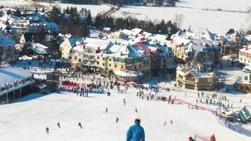 A snowy town with a ski slope and buildings.